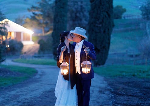 Couple walking with lanterns at twilight