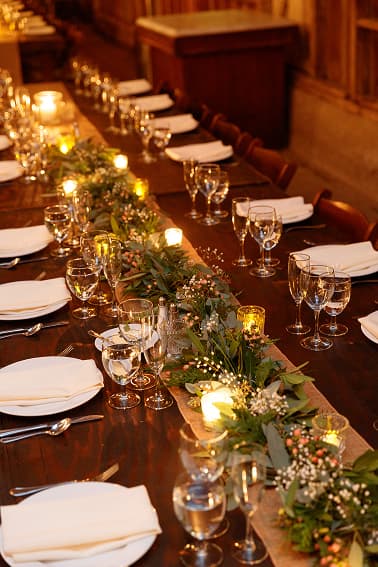 Long table set with candles and greenery
